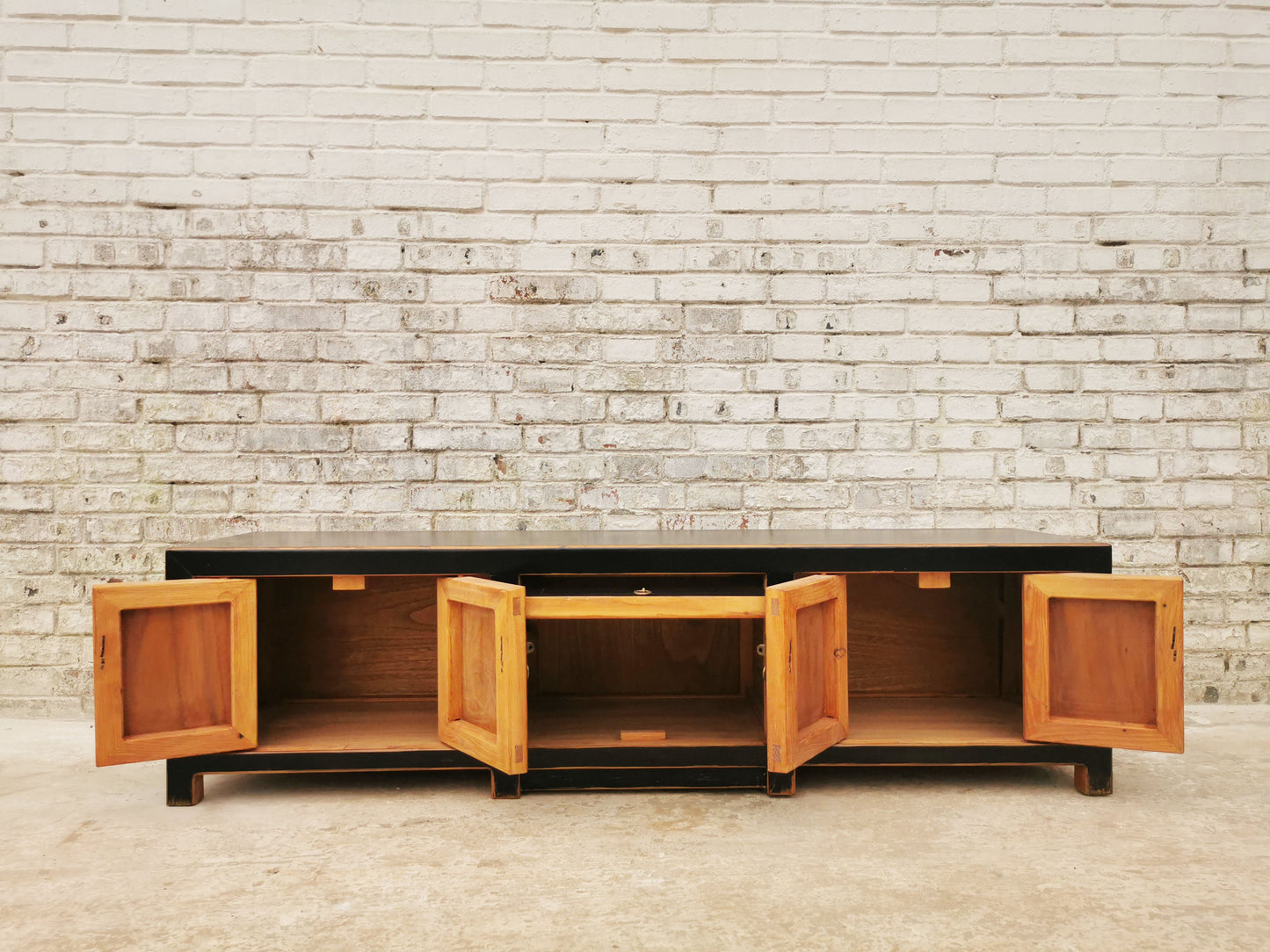 TV Lowboard in modernem Design mit traditionellen Details in Gold.